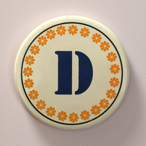 Monogram D coaster